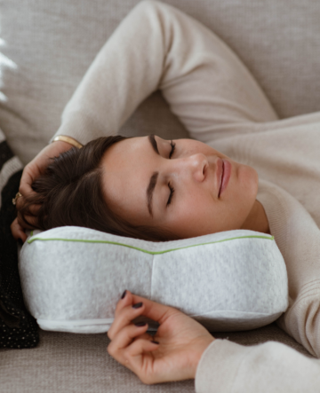 Woman relaxing on blackroll pillow